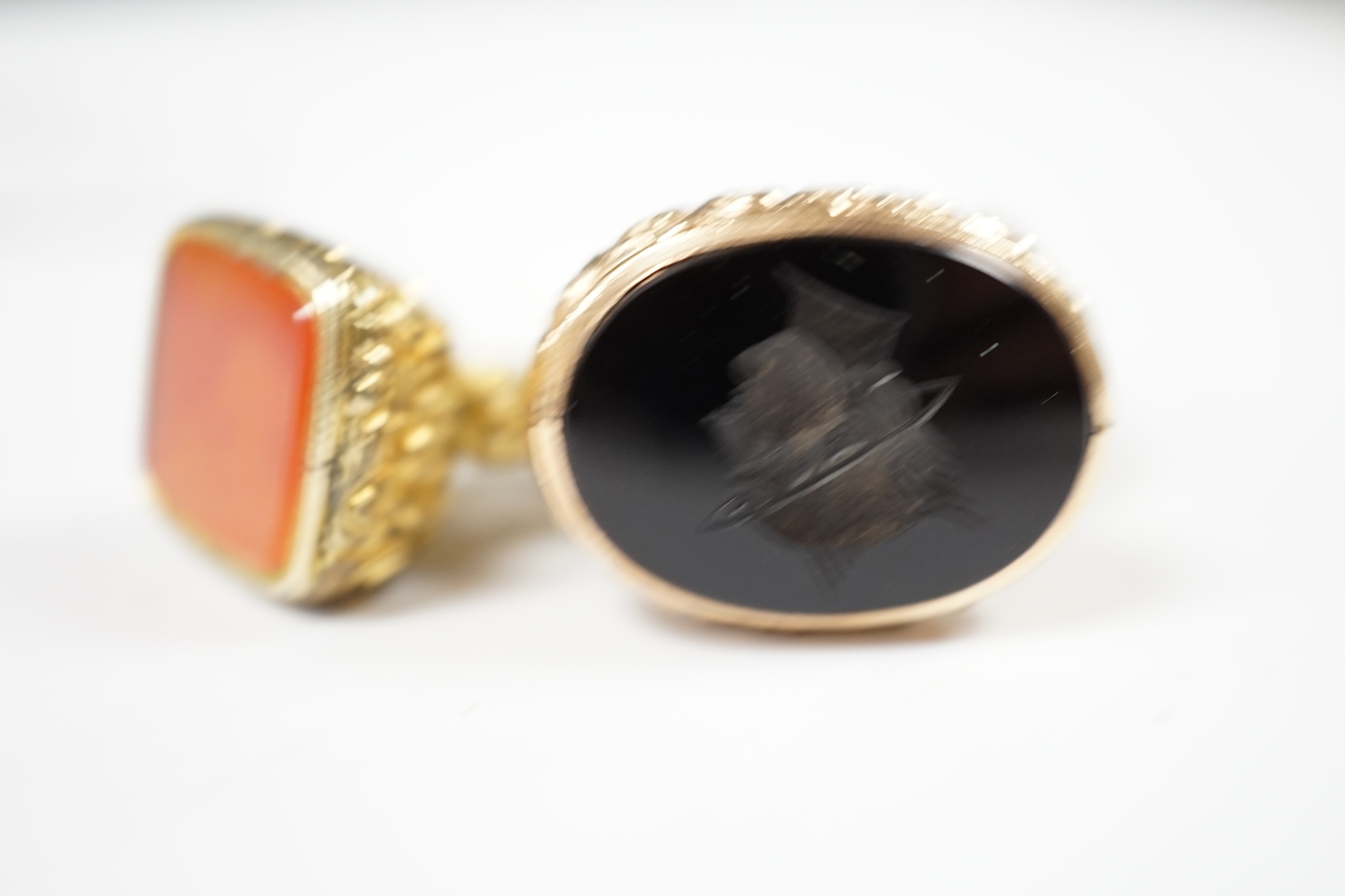 Four assorted Victorian and later yellow metal overlaid and chalcedony/quartz set fob seals, largest 26mm. Condition - poor to fair